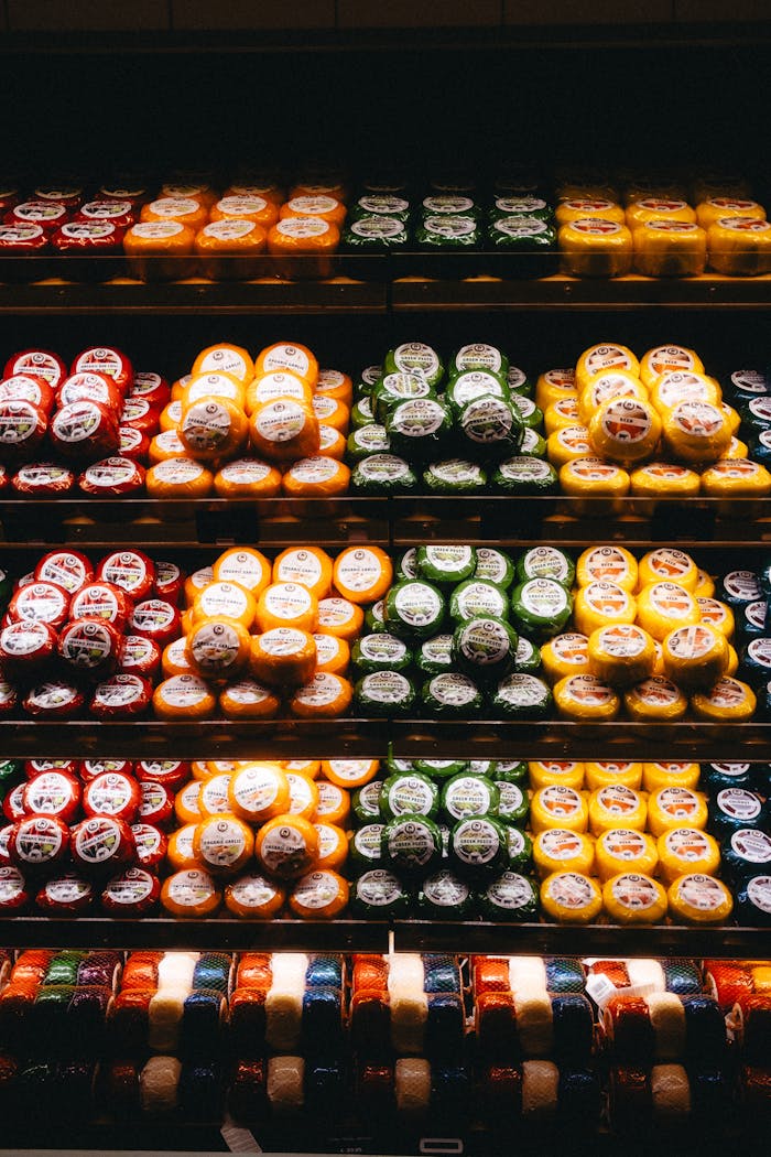 home-hero Colorful display of diverse cheese selection on shelves in an Amsterdam shop.